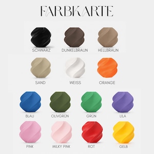 May include: A color chart titled FARBKARTE displaying fourteen twisted, spherical objects in various solid colors including black, dark brown, light brown, sand, white, orange, blue, olive green, green, purple, pink, milky pink, red, and yellow.
