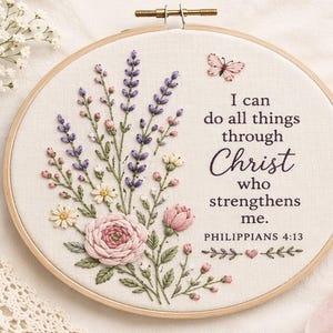 May include: Embroidered hoop art featuring a floral design with lavender, pink roses, and small white flowers. A pink butterfly and the text "I can do all things through Christ who strengthens me. Philippians 4:13" are also included.