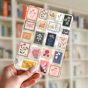 May include: A rectangular tablet case featuring a repeating pattern of vintage-style postage stamps on a light green checkered background. The stamps display various illustrations including flowers, a bicycle, a dragonfly, and the text POSTAGE and XOXO.