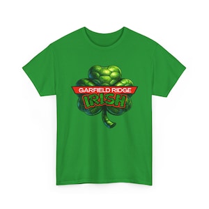 May include: Green t-shirt with a shamrock design and the text "GARFIELD RIDGE IRISH" in a red banner. The shamrock is a detailed green illustration. The text is in a bold font. A St. Patrick's Day themed tee.