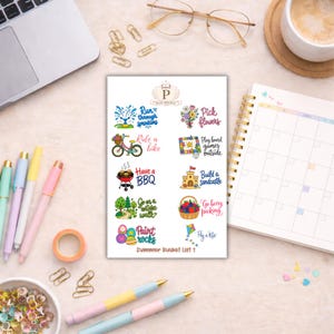 May include: A sheet of summer-themed stickers with colorful illustrations and text, including "Run through sprinklers," "Ride a bike," and "Have a BBQ." The stickers are on a light-colored surface with pens and a laptop.