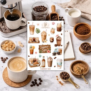 May include: An overhead shot of coffee-themed items. A sticker sheet with various coffee drinks, a cup of coffee, coffee beans, sugar cubes, and a coffee machine. The sticker sheet has the text "Summer Sips".