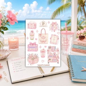May include: Aesthetic flat lay featuring a pink and white sticker sheet with illustrations of books, tote bags, and drinks. A clear tumbler with a pink lid and straw reads "salty hair don't care." A notebook and candle are also present.