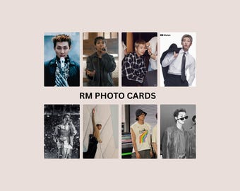 May include: A collection of eight rectangular photo cards featuring RM, arranged in two rows of four. The text RM PHOTO CARDS is centered between the rows. The images show various portraits and candid shots of the individual in different outfits.