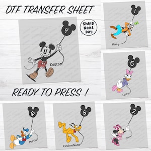 a collection of cartoon character illustrations, including Mickey Mouse, Donald Duck, Minnie Mouse, and Pluto. The characters are holding balloons with numbers on them, and the image includes text that reads "DFT Transfer Sheet" and "Ready to Press!".
