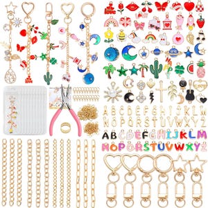 May include: A collection of jewelry-making supplies, including gold-colored chains, keychains, and charms. Charms feature various designs like hearts, stars, and letters. A pair of pink pliers and small gold rings are also included.