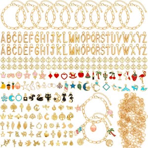 May include: A collection of gold-colored jewelry-making supplies, including bracelets, alphabet charms, and various decorative charms. The charms feature designs like stars, hearts, and animals. The bracelets are made of a chain link design.