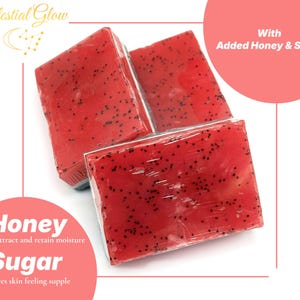 May include: Three red soap bars with black specks, wrapped in clear plastic. The image includes text that says "Celestial Glow", "With Added Honey & Sugar", "Honey Helps attract and retain moisture", and "Sugar Leaves skin feeling supple".