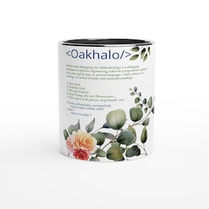 May include: White ceramic mug with the text "<Oakhalo/>" and a description of rubber duck debugging. The mug is decorated with watercolor flowers and greenery. A perfect gift for software engineers.
