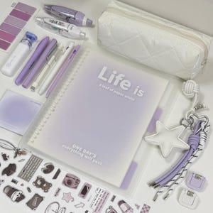 May include: A spiral-bound notebook with a translucent cover featuring the text Life is a leaf of paper white and ONE DAY'S everything will pass, accompanied by a white quilted pencil case, purple pens, a glue pen, stickers, and a star keychain.