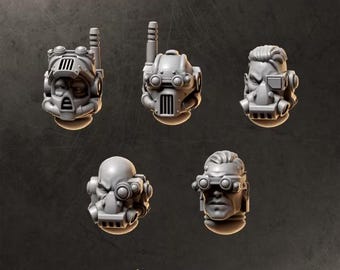 May include: Five grey miniature heads for gaming figures, labeled HEADS 3 and GREYTIDE STUDIO. The set includes three helmeted heads with antennas and visors, and two heads with goggles and breathing apparatuses, all featuring detailed mechanical designs.