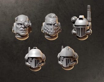 May include: A set of five grey miniature heads labeled HEADS 2 and GREYTIDE STUDIO. The collection includes one bare head with a cybernetic eye, one head with a respirator mask, and three armored helmets with various visors, antennas, and sensors.