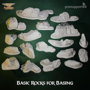 Pode incluir: Coleção de modelos de rochas de vários tamanhos e cores claras, para modelagem. Os modelos têm diferentes formas e texturas. O texto "BASIC ROCKS FOR BASING" é exibido na parte inferior da imagem.
