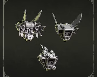 May include: Three grey resin miniature jetpacks with mechanical details, including wing-like stabilizers, circular thrusters, and skull motifs. The top text reads Jetpacks and the bottom text reads Greytide Studio. These components are unpainted.