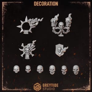 May include: A collection of grey miniature gaming accessories including a spiked ring with flames, a double torch candelabra with a skull, a skull surrounded by bones, a shield with a skull and flames, and six individual human skull figurines.