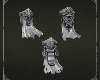 May include: Three grey miniature loincloth accessories for gaming figures, each featuring distinct sculpted details including skulls, winged emblems, and chain links. The top text reads Loincloths 2 and the bottom logo reads GREYTIDE STUDIO.