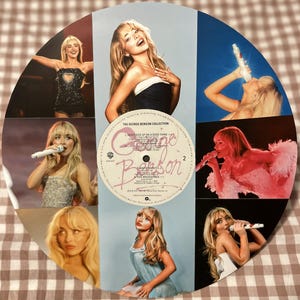 May include: A circular collage featuring images of a blonde woman, a vintage vinyl record, and a light brown background. The record is labeled "The George Benson Collection" with song titles. The woman is shown in various poses, including singing into a microphone.