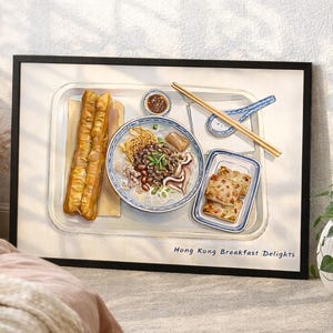 May include: A framed watercolour print depicting a Hong Kong breakfast. The image shows a tray with noodles, fried dough sticks, and a small bowl of sauce. The text "Hong Kong Breakfast Delights" is visible.