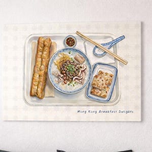 May include: A set of three ceramic nesting bowls. The largest bowl is light blue, the medium bowl is white, and the smallest bowl is a darker blue. Each bowl has a smooth, glossy finish.