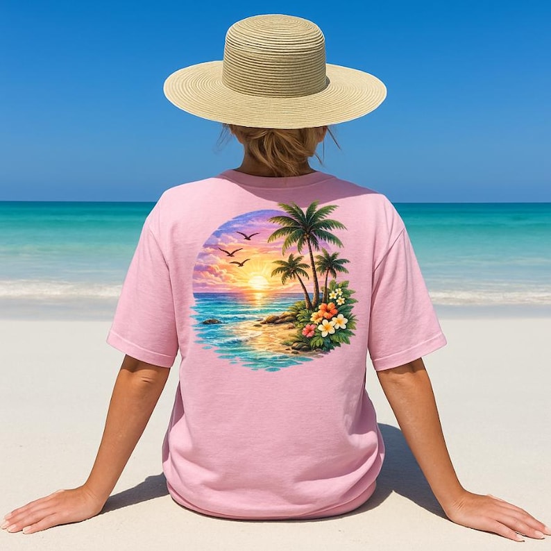 May include: A light pink t-shirt with a tropical sunset design on the back. The design features palm trees, flowers, birds, and a vibrant sunset over the ocean. A straw hat is worn.