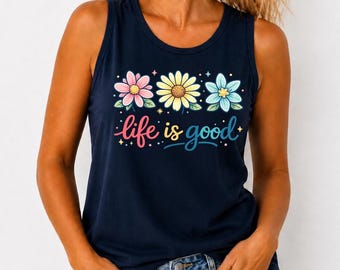 May include: Navy blue tank top with a floral design and the phrase "life is good" in colorful script. The top features three flowers in pink, yellow, and blue, with small star accents. A casual and cheerful summer top.