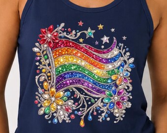 May include: A navy blue tank top featuring a central graphic of a glittery, multi-colored rainbow wave. The design is framed by intricate silver-toned floral embellishments and scattered stars, creating a vibrant, textured appearance on the fabric.