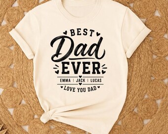 May include: A cream-colored short-sleeve t-shirt featuring black text that reads BEST DAD EVER with the names EMMA, JACK, and LUCAS printed below, followed by the text LOVE YOU DAD, all accented with small heart icons and decorative lines.