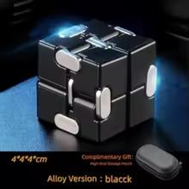May include: A black alloy fidget cube with silver accents. The cube is 4" x 4" x 4" and comes with a complimentary storage pouch. The text "Alloy Version: black" is visible.