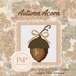 Op de afbeelding: Een digitaal kruissteekpatroon getiteld Autumn Acorn met een gepixelde bruine eikel met een beige strik en een steeltje. Het ontwerp is gecentreerd op een wit raster binnen een geschulpt kader, met de tekst P&P Pepper & Pearl en Digital Stitch Chart.