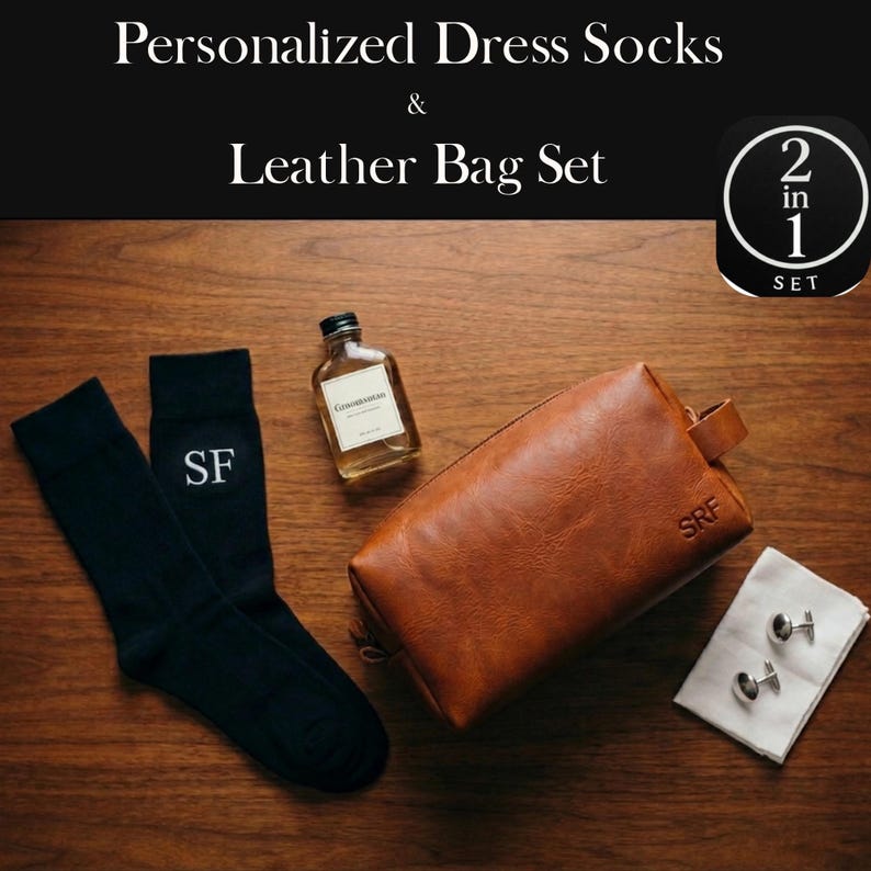 May include: A gift set featuring personalized dress socks and a leather bag. The image displays black socks with "SF" embroidery, a brown leather bag with "SRF" embossed, a small bottle, and cufflinks on a white cloth. The text reads "Personalized Dress Socks & Leather Bag Set".