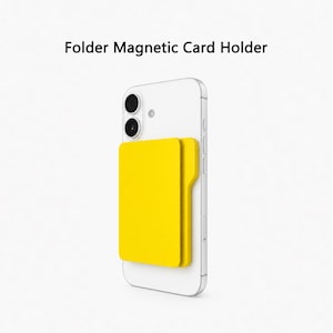 Könnte beinhalten: Ein leuchtend gelber magnetischer Kartenhalter, der an der Rückseite eines weißen Smartphones befestigt ist. Der Kartenhalter hat ein ordnerartiges Design mit einer Lasche auf der rechten Seite. Der Text Folder Magnetic Card Holder steht über dem Gerät.