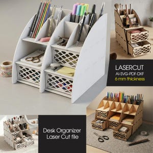 May include: A white desk organizer with multiple compartments and drawers, holding pens, pencils, and stationery. The organizer has a lattice design on the drawers and is made of wood. The text "Desk Organizer Laser Cut file" is visible.