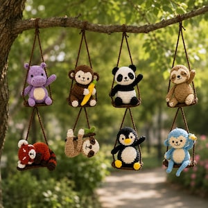 May include: A collection of eight crocheted animal ornaments hanging from a tree branch. The animals include a purple hippo, brown monkey with a banana, panda, sloth, red panda, penguin, and blue monkey, each on a swing.
