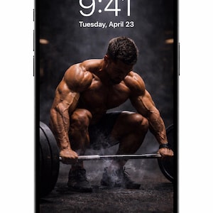 May include: Smartphone screen showing a muscular person lifting a barbell. The time displayed is 9:41 AM, Tuesday, April 23. The phone is black with a white border.