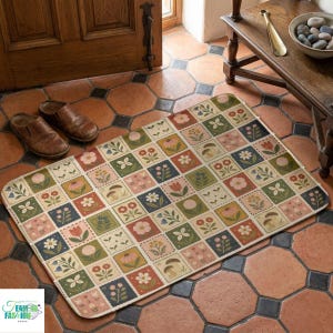 May include: A rectangular doormat with a floral and botanical design. The mat features a grid pattern of squares, each containing a different flower or plant illustration in shades of pink, green, blue, and yellow. The mat is placed on a tiled floor.