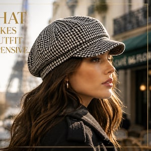 May include: A black and white houndstooth patterned hat with a short brim. The hat is worn by a person in front of a blurred Parisian street scene. The text on the image reads: "THE HAT THAT MAKES EVERY OUTFIT LOOK EXPENSIVE."