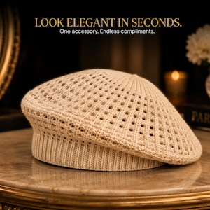 May include: A beige knit beret featuring a textured openwork pattern on the crown and a solid ribbed band. The text LOOK ELEGANT IN SECONDS. One accessory. Endless compliments. is displayed above the hat in a clear, sans-serif font.