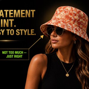 May include: A woman wearing a floral print bucket hat, sunglasses, and gold jewelry. The hat has a red and white floral pattern. The text on the image reads "STATEMENT PRINT. EASY TO STYLE. NOT TOO MUCH - JUST RIGHT."