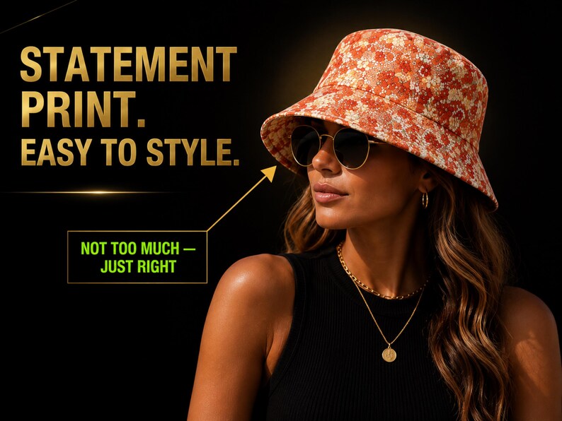 May include: A woman wearing a floral print bucket hat, sunglasses, and gold jewelry. The hat has a red and white floral pattern. The text on the image reads "STATEMENT PRINT. EASY TO STYLE. NOT TOO MUCH - JUST RIGHT."