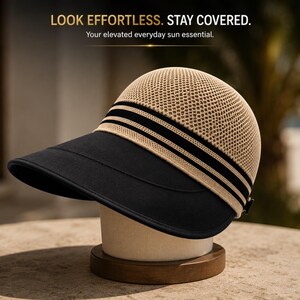 May include: A sun hat with a beige mesh crown and a wide black brim. The hat features black and beige striped detailing around the base of the crown. Text at the top reads: LOOK EFFORTLESS. STAY COVERED. Your elevated everyday sun essential.