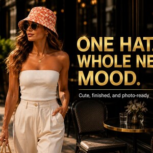 May include: A woman wearing a floral bucket hat, sunglasses, a white tube top, and beige pants. The image includes the text "ONE HAT. WHOLE NEW MOOD. Cute, finished, and photo-ready."