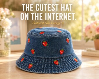 May include: A denim bucket hat with embroidered red strawberries. The hat has a classic brim and is made of blue denim. Text on the image reads "THE CUTEST HAT ON THE INTERNET." and "Pinterest Girl Energy."