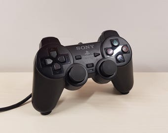 Soporte de pared invisible para mando de Sony Playstation 2, organizador de configuración de juegos, color negro.