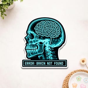 May include: A sticker featuring a teal-colored illustration of a human skull in profile, with a tangled brain design. The text "ERROR: BRAIN NOT FOUND" is displayed in a black rectangle below the skull. The sticker has a white border.