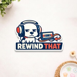 May include: A sticker featuring a cartoon dog wearing headphones and a cassette tape. The dog is white with black and red accents, and the text "REWIND THAT" is displayed in a blue and red banner.