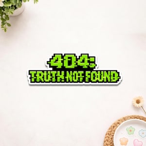 May include: A white sticker with the text "404: TRUTH NOT FOUND" in pixelated green letters on a black background. The sticker is rectangular and has a white border.