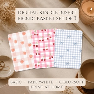 May include: A set of three rectangular digital Kindle inserts featuring a picnic basket theme. One insert has a light pink gingham pattern with peaches, one has a pink gingham pattern with cherries, and one has a light blue gingham pattern with bows.