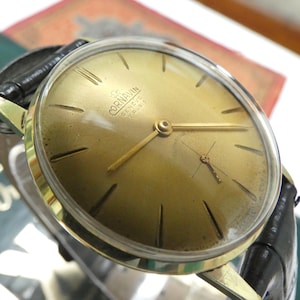 This beautiful vintage Swiss CORNAVIN GENEVE 17 Jewels watch from the 1960s with a stunning gold stardust dial is ready to wear