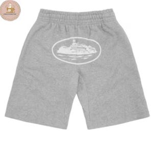 May include: Light gray sweat shorts featuring an elasticized waistband and a white oval graphic on the center back. The graphic depicts a detailed illustration of a large cruise ship sailing on water, enclosed within a solid white oval border.