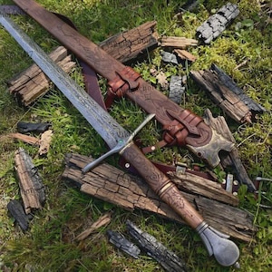 May include: A double-edged steel sword with an intricate etched pattern on the blade, a crossguard with a small green stone, and a brown leather-wrapped handle. It is accompanied by a matching brown leather scabbard with embossed detailing.